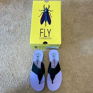 Fly London black and purple wedge flip flops.